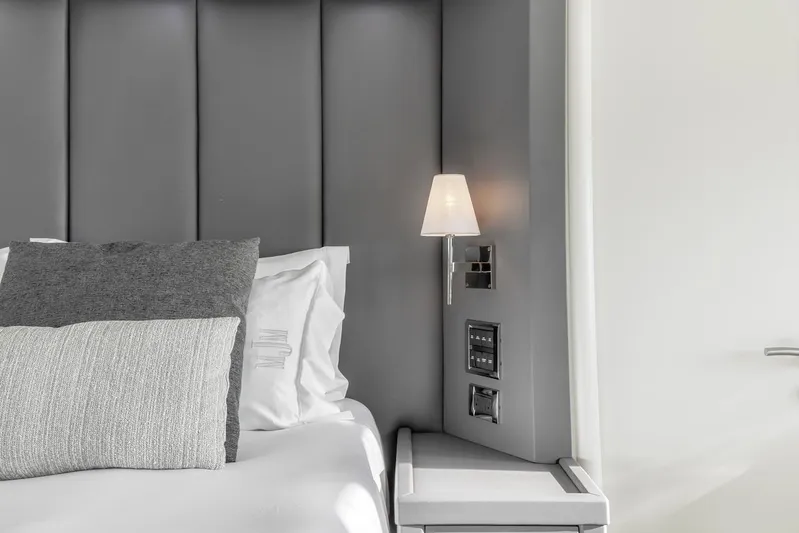 Skyfall Yacht Photos Pics Luxurious Sunseeker Predator 108 bedroom interior with modern gray headboard and elegant lighting, 2008 model.