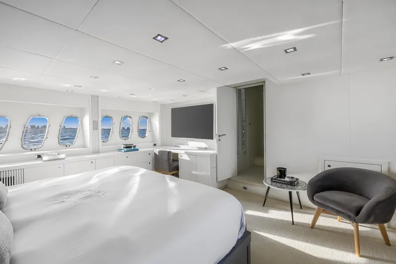 Skyfall Yacht Photos Pics Luxurious Sunseeker Predator 108 yacht bedroom with ocean view, modern decor, and elegant furnishings.