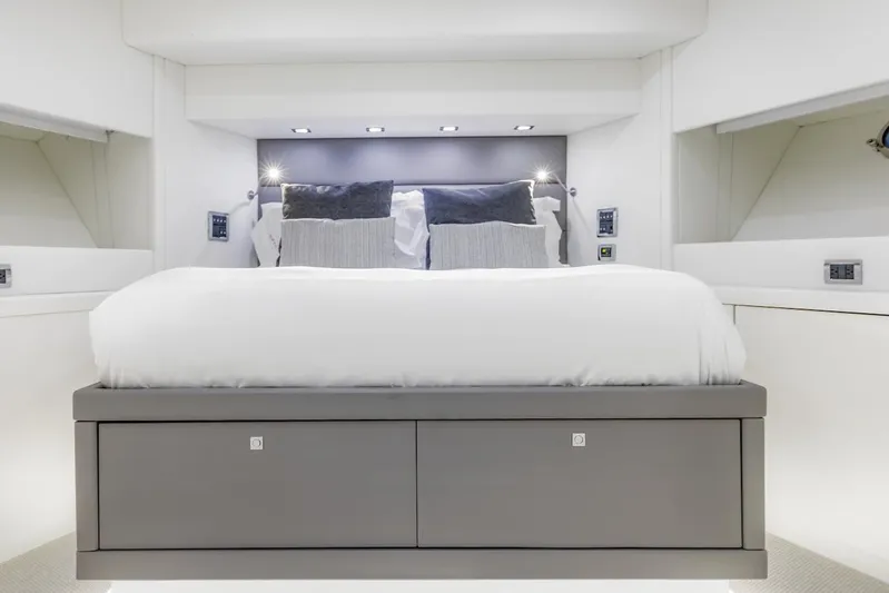 Skyfall Yacht Photos Pics Luxurious bedroom interior of 2008 Sunseeker Predator 108 yacht, featuring modern design and elegant bedding.