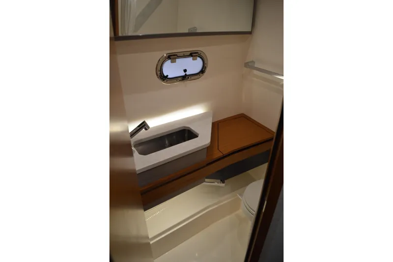 Hopena Yacht Photos Pics 2024 Tiara Yachts 34 LS bathroom interior with sink, porthole, and modern design.