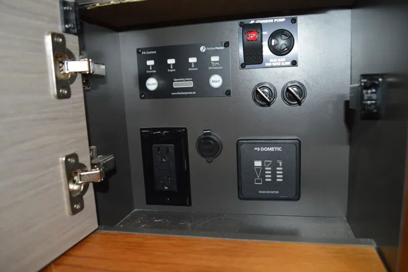 Hopena Yacht Photos Pics Control panel inside 2024 Tiara Yachts 34 LS, featuring switches and tank monitor.