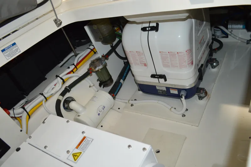 Hopena Yacht Photos Pics Engine compartment of 2024 Tiara Yachts 34 LS, showcasing mechanical components and wiring.