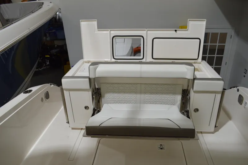 Hopena Yacht Photos Pics 2024 Tiara Yachts 34 LS interior with white seating and storage compartments.