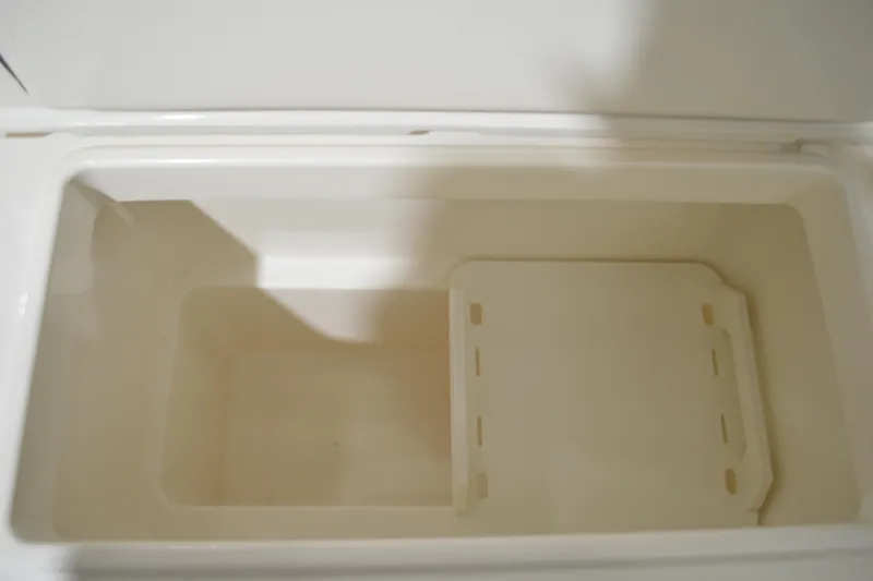 Hopena Yacht Photos Pics Open storage compartment in 2024 Tiara Yachts 34 LS, featuring a removable divider.