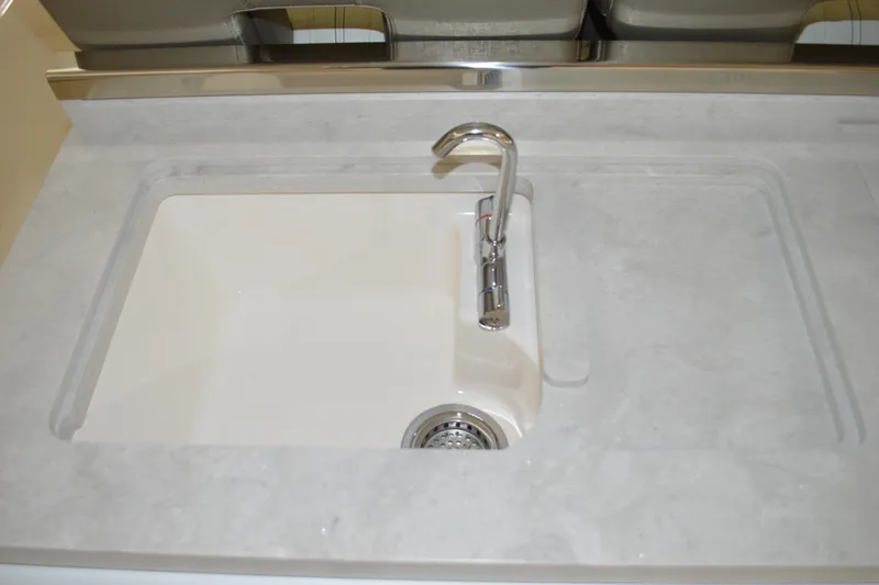 Hopena Yacht Photos Pics 2024 Tiara Yachts 34 LS sink with modern faucet and sleek countertop design.