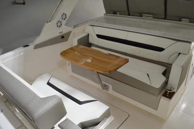 Hopena Yacht Photos Pics 2024 Tiara Yachts 34 LS interior with elegant seating and wooden table.