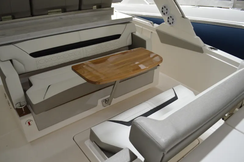 Hopena Yacht Photos Pics 2024 Tiara Yachts 34 LS interior with elegant seating and wooden table.