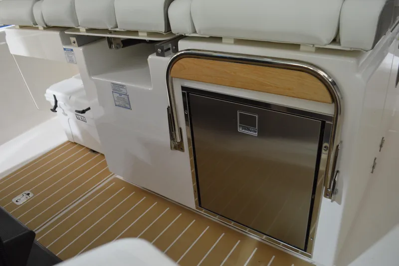 Hopena Yacht Photos Pics 2024 Tiara Yachts 34 LS interior with stainless steel fridge and cushioned seating.