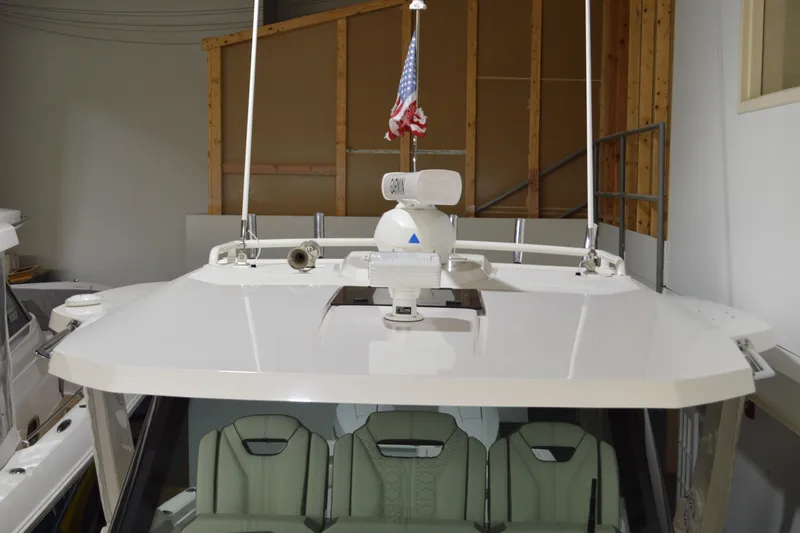 Hopena Yacht Photos Pics 2024 Tiara Yachts 34 LS boat with radar and American flag in a storage facility.