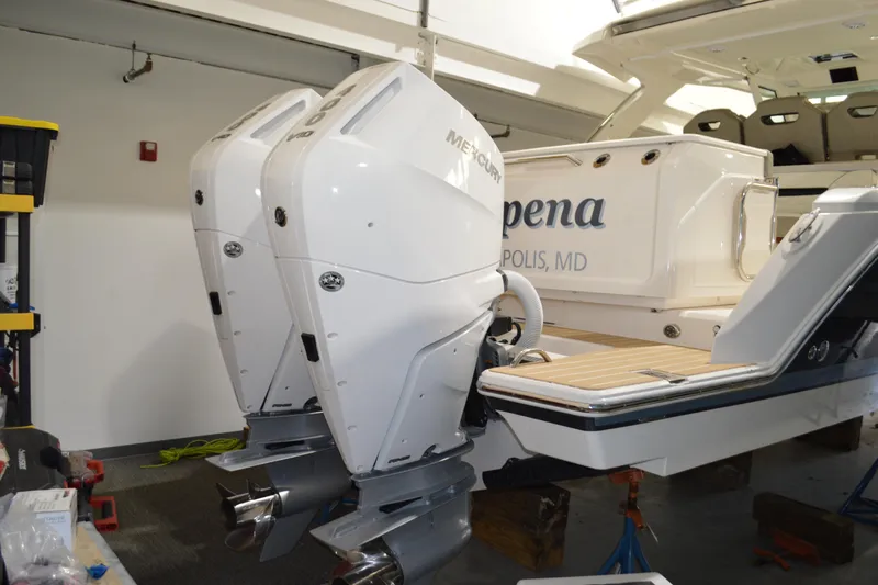 Hopena Yacht Photos Pics 2024 Tiara Yachts 34 LS with dual Mercury outboard engines in a showroom.