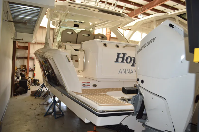Hopena Yacht Photos Pics 2024 Tiara Yachts 34 LS in a storage facility, featuring Mercury outboard engine.