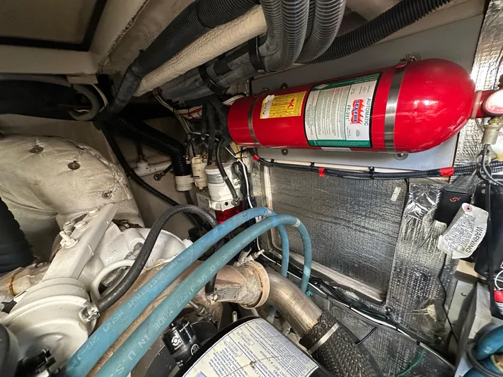 Mother Ship Yacht Photos Pics Engine room of 2011 Meridian 441 Sedan Bridge, featuring fire extinguisher and various components.