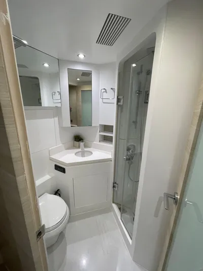  Yacht Photos Pics Compact modern bathroom in 2017 Horizon PC60 yacht, featuring shower, toilet, and sink.