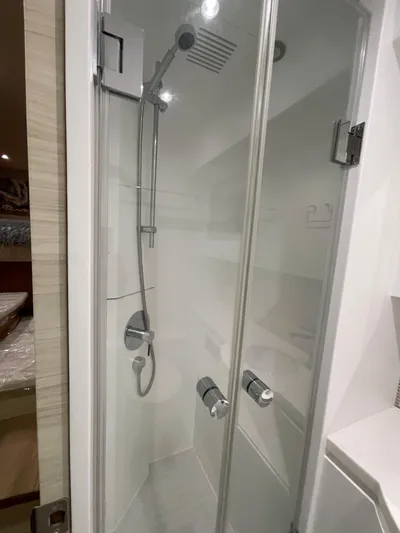  Yacht Photos Pics Modern shower cabin in 2017 Horizon PC60 yacht, featuring sleek glass doors and chrome fixtures.