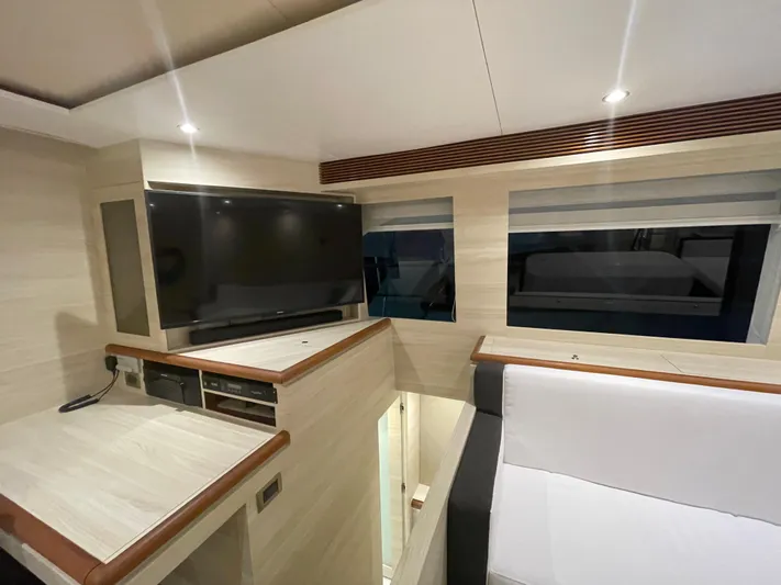  Yacht Photos Pics Modern interior of 2017 Horizon PC60 yacht with TV and seating area.