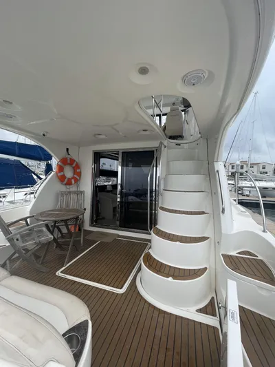 Mother Ship Yacht Photos Pics 2011 Meridian 441 Sedan Bridge yacht interior with wooden deck and spiral staircase.