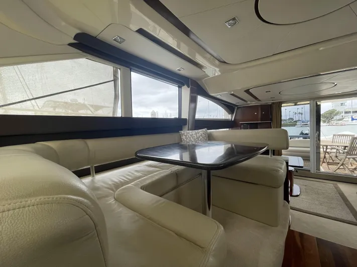 Mother Ship Yacht Photos Pics Luxurious interior of 2011 Meridian 441 Sedan Bridge yacht with elegant seating and table.