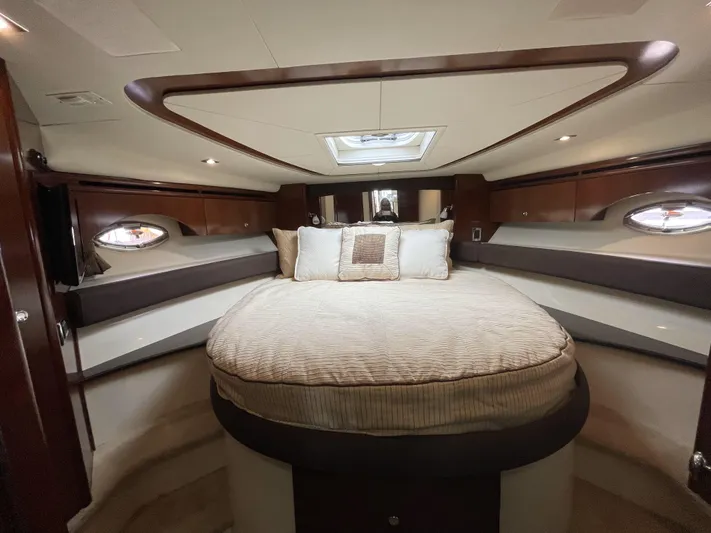 Mother Ship Yacht Photos Pics Luxurious 2011 Meridian 441 Sedan Bridge bedroom with elegant wood accents and plush bedding.