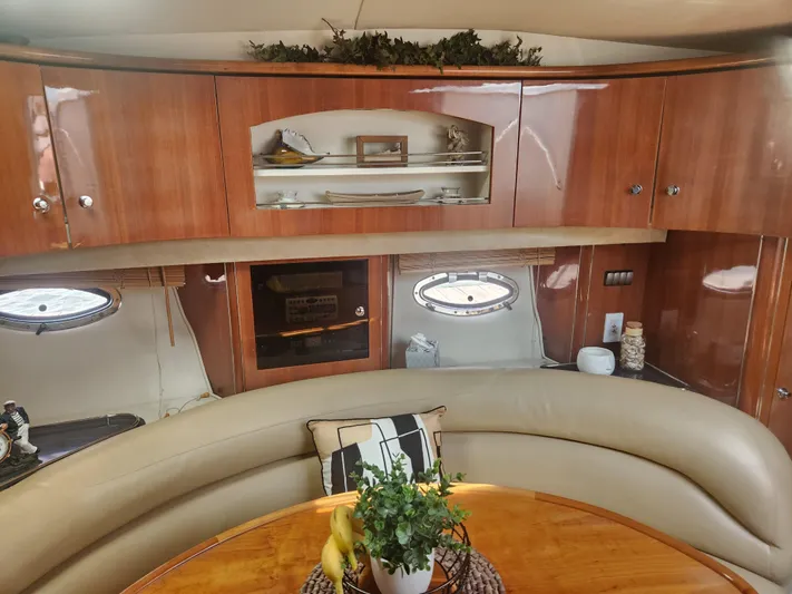 Empty Pockets Yacht Photos Pics Luxurious interior of 2006 Doral Boca Grande yacht with elegant wood cabinetry and plush seating.
