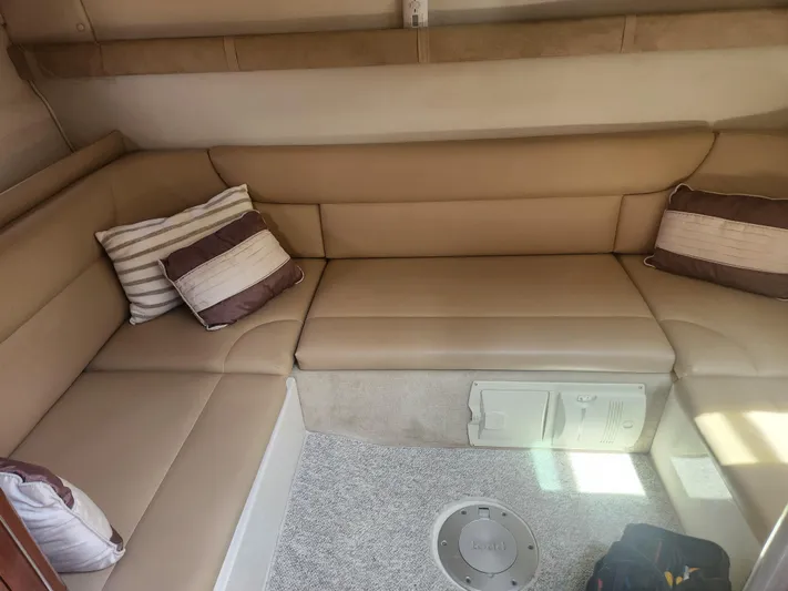 Empty Pockets Yacht Photos Pics 2006 Doral Boca Grande boat interior with beige seating and striped cushions.