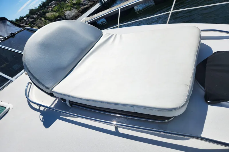 Empty Pockets Yacht Photos Pics Sunpad on 2006 Doral Boca Grande boat, docked near water.