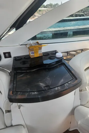 Empty Pockets Yacht Photos Pics 2006 Doral Boca Grande boat interior with sleek black countertop and cup holders.