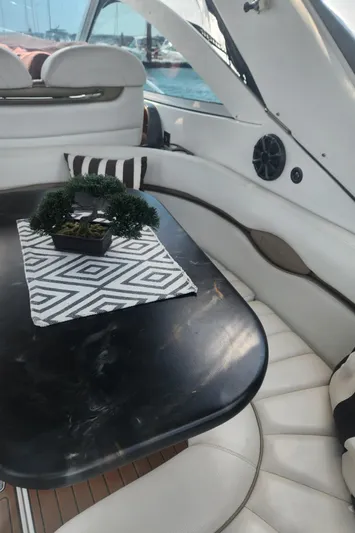 Empty Pockets Yacht Photos Pics Interior of 2006 Doral Boca Grande yacht with elegant seating and table.