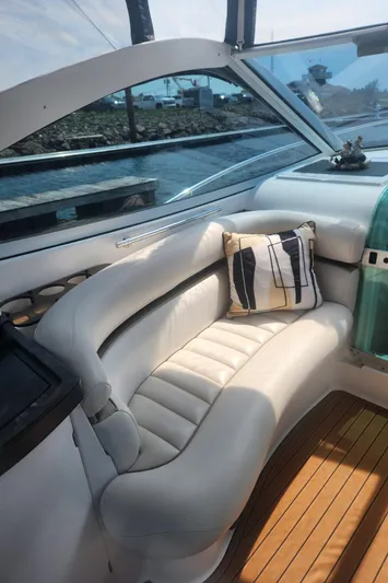 Empty Pockets Yacht Photos Pics 2006 Doral Boca Grande boat interior with white seating and striped pillow.