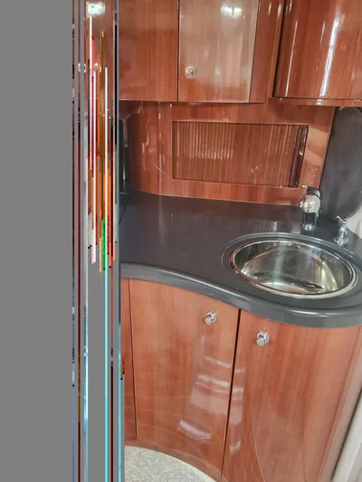 Empty Pockets Yacht Photos Pics 2006 Doral Boca Grande yacht interior with wood cabinetry and compact sink.