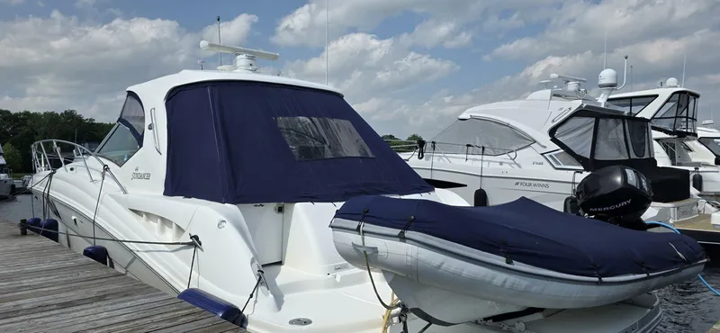  Yacht Photos Pics 2008 Sea Ray 44 Sundancer yacht docked with inflatable boat, under a partly cloudy sky.