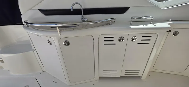  Yacht Photos Pics 2008 Sea Ray 44 Sundancer yacht kitchenette with sink and storage cabinets.