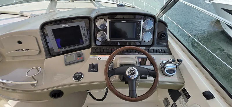  Yacht Photos Pics Helm of 2008 Sea Ray 44 Sundancer with navigation controls and steering wheel.