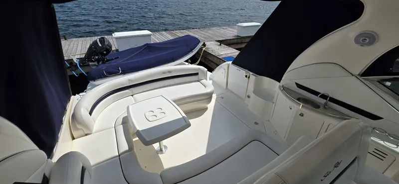  Yacht Photos Pics 2008 Sea Ray 44 Sundancer yacht interior with seating and table, docked by the water.