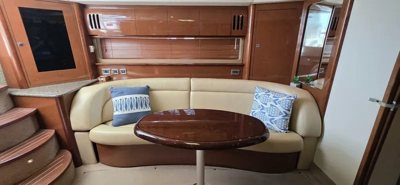  Yacht Photos Pics 2008 Sea Ray 44 Sundancer interior with beige seating, wooden table, and decorative pillows.