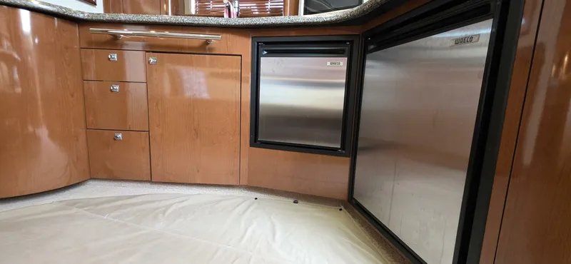  Yacht Photos Pics 2008 Sea Ray 44 Sundancer kitchen with wood cabinetry and stainless steel appliances.