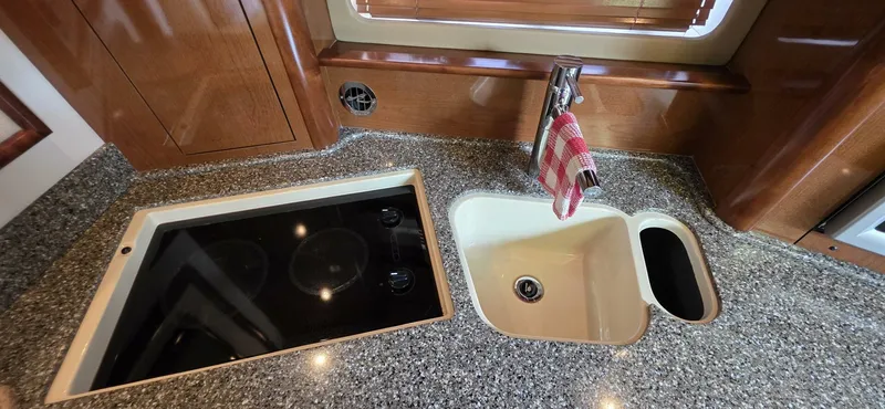  Yacht Photos Pics 2008 Sea Ray 44 Sundancer kitchen with granite countertop, sink, and stovetop.