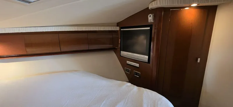  Yacht Photos Pics Interior cabin of 2008 Sea Ray 44 Sundancer with TV and wooden cabinetry.
