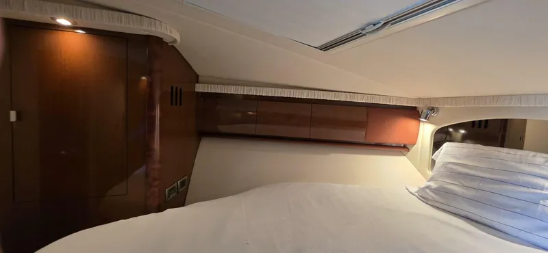  Yacht Photos Pics Interior cabin of 2008 Sea Ray 44 Sundancer with wood paneling and bed.
