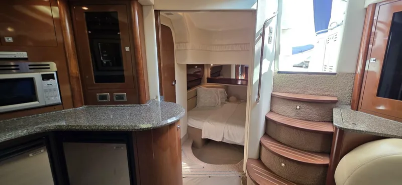  Yacht Photos Pics Interior of 2008 Sea Ray 44 Sundancer yacht, featuring kitchen and cozy bedroom.