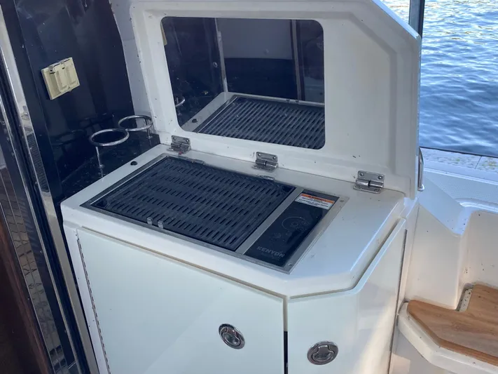  Yacht Photos Pics Outdoor grill on 2015 Sea Ray 510 Sundancer yacht, near water.