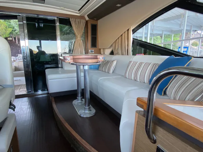  Yacht Photos Pics Luxurious interior of 2015 Sea Ray 510 Sundancer yacht with elegant seating and table.