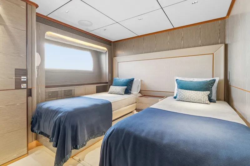 Wild Duck Yacht Photos Pics Luxurious twin bedroom in 2019 Horizon RP110 yacht with elegant decor and blue accents.
