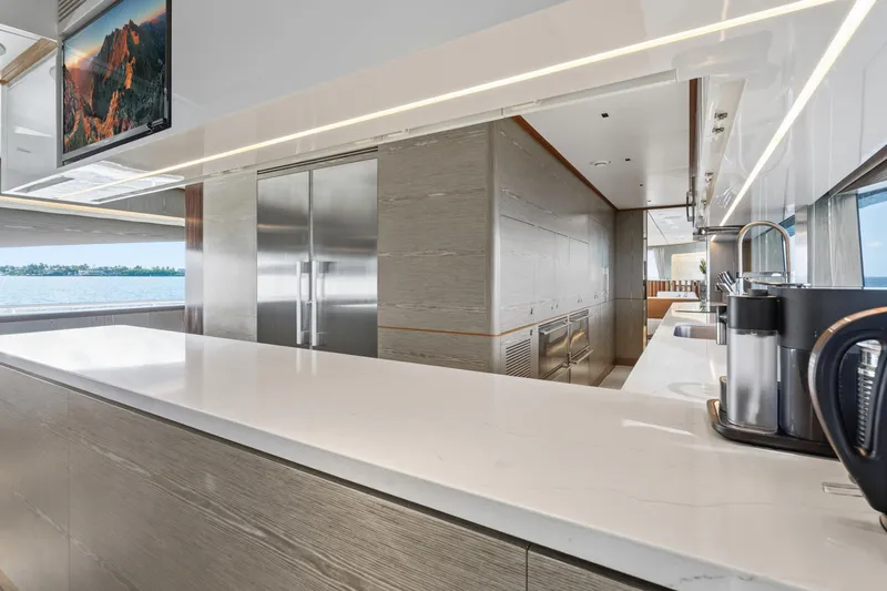 Wild Duck Yacht Photos Pics Luxurious yacht kitchen interior with modern appliances, sleek countertops, and ocean view. Horizon RP110, 2019.