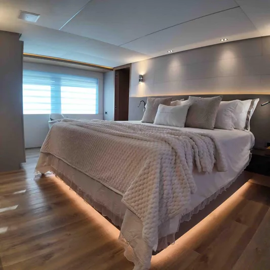  Yacht Photos Pics Luxurious bedroom interior on Inace AVENTURA 106 yacht, 2027 model, featuring elegant lighting and cozy bedding.