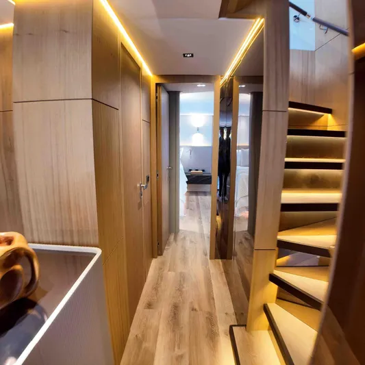  Yacht Photos Pics Luxurious interior of 2027 Inace AVENTURA 106 yacht with modern wooden design and staircase.