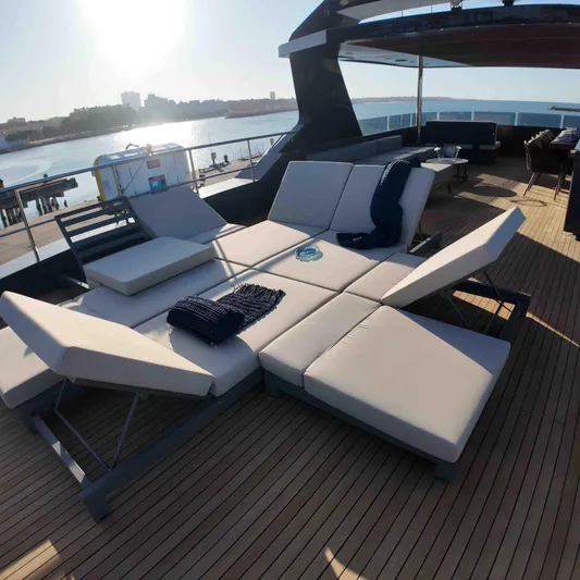  Yacht Photos Pics Luxurious deck seating on 2027 Inace AVENTURA 106 yacht, overlooking serene waterfront.