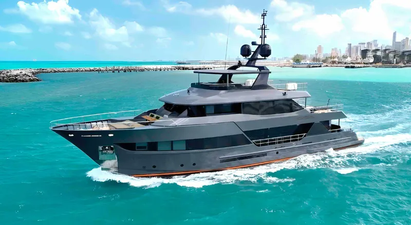  Yacht Photos Pics Luxurious 2027 Inace AVENTURA 106 yacht cruising in turquoise waters near a cityscape.