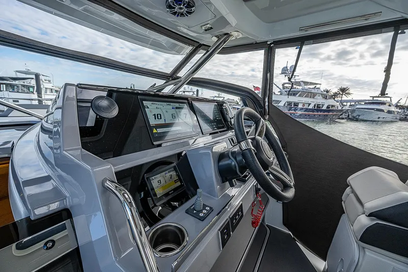 Brama Sole Yacht Photos Pics 2022 Jeanneau Leader 12.5 helm with modern navigation system, docked at marina.