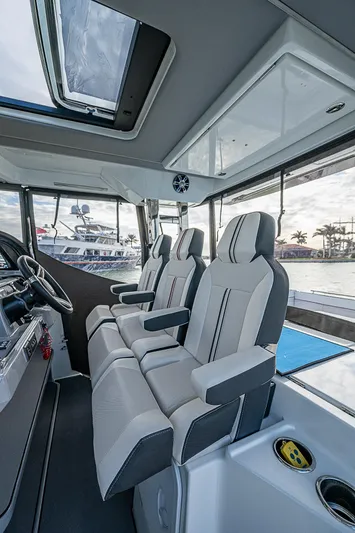 Brama Sole Yacht Photos Pics Interior of 2022 Jeanneau Leader 12.5 boat with modern seating and panoramic windows.