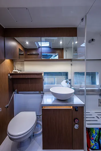 Brama Sole Yacht Photos Pics 2022 Jeanneau Leader 12.5 yacht bathroom with modern fixtures and wood accents.